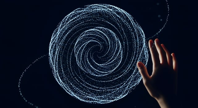 A person's hand is touching a circular object photo