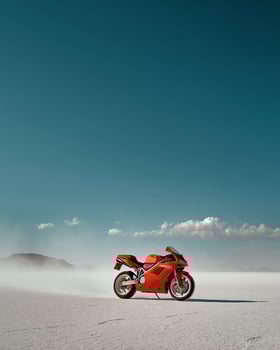 Bold Red Motorbike Riding Solo Over Salt Desert With Flying Dust Clouds and Clear Horizon Framed in Modern Minimalist Photography photo