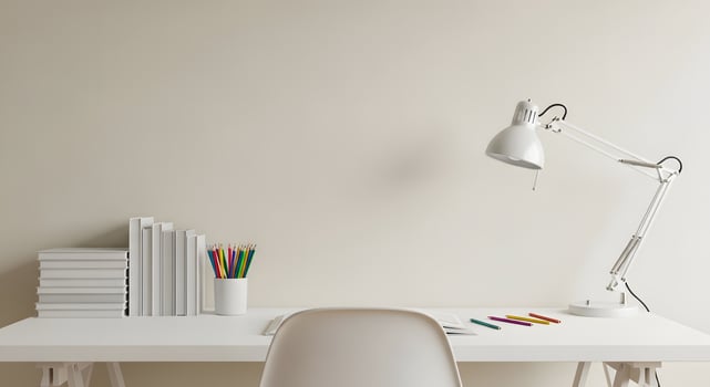 White desk with a lamp and books on it photo