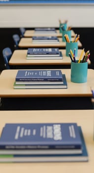 A classroom with books and pencils on the table photo