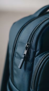 A close up of a blue backpack with zippers photo