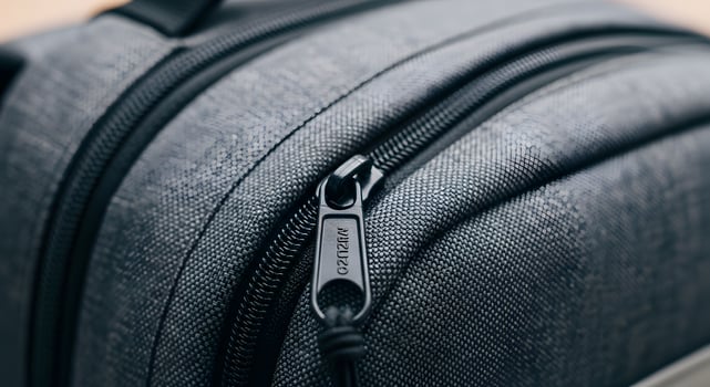 A close up of a gray backpack with a zipper photo