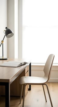 A desk and chair in a room with a window photo