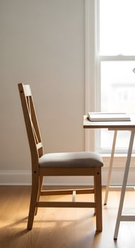 A chair and desk in front of a window photo