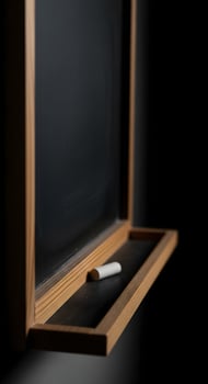 A blackboard with a pencil on it in front of a blackboard photo