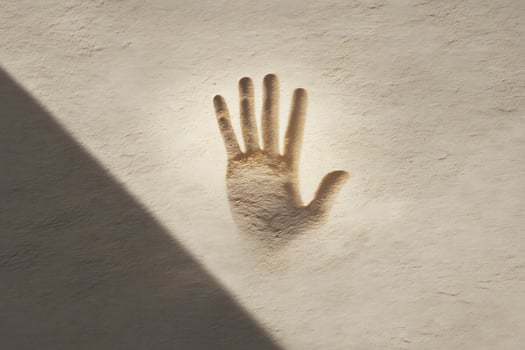 Sand Handprint in Bright Sunlit Beach Scene with Soft Shadows and Natural Texture for Artistic and Creative Use photo