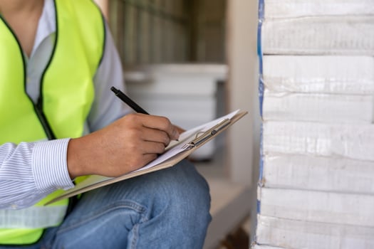 inspector or engineer is inspecting construction house using a checklist. Engineers and architects or contactor count materials for construction. Building, check, insurance house. photo