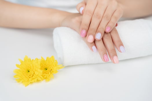 Woman show beautiful nail after receive care service by professional Beautician Manicure at spa centre. Nail beauty salon use nail file for Glazing treatment.. photo