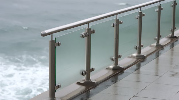 Modern Glass Balcony Railing Overlooking the Ocean Waves. photo