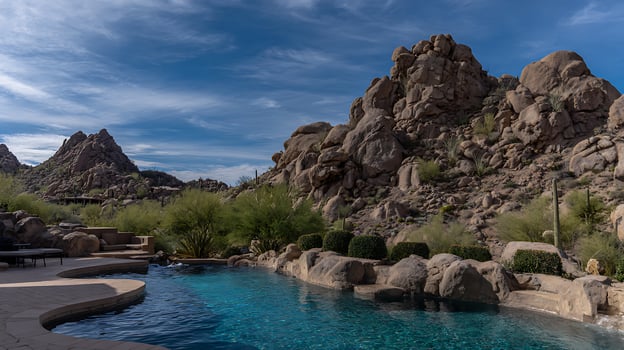 Desert Oasis Swimming Pool with Mountain Backdrop and Sunny Skies. photo