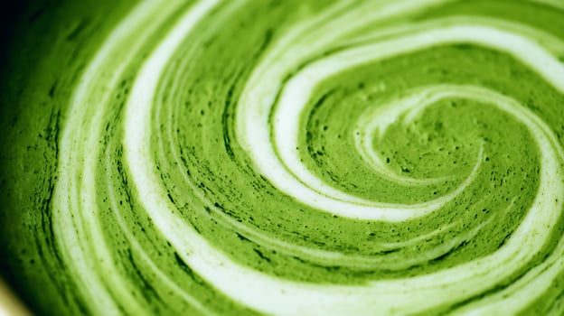Swirling Green Matcha Latte Art Close Up with Creamy Foam Texture. photo