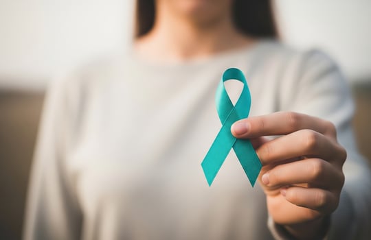 Hand Holding Teal Ribbon for Awareness and Support Against Sexual Assault and Violence with Symbolic Message of Hope and Prevention photo