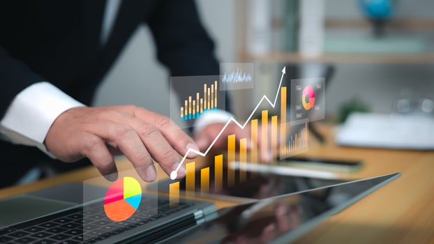 Analysis of business data with futuristic charts, rising trend line, and professional hands on laptop, symbolizing growth, investment, and digital financial strategy. photo