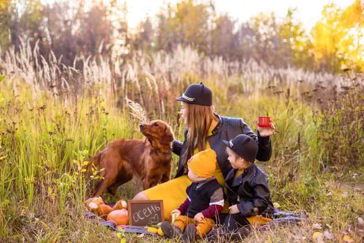 funny family with a golden retriever dog on a walk in autumn sunny nature photo
