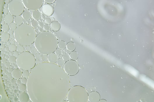 Top view of close up of oil swirling on water photo