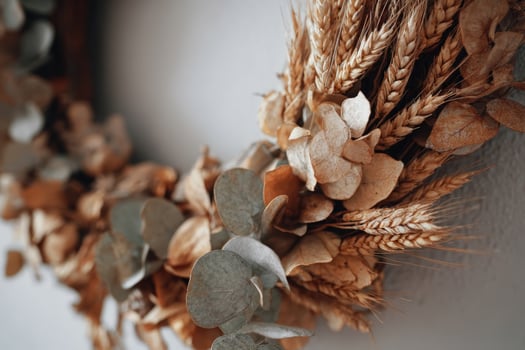 Dried floral arrangement featuring eucalyptus and wheat for home decor near natural light photo