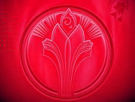 Vibrant Red Art Deco Floral Emblem Circular Design Texture photo