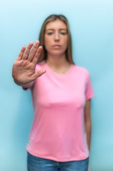 vertical Woman showing stop sign with hand wearing pink t-shirt for Breast Cancer Awareness photo