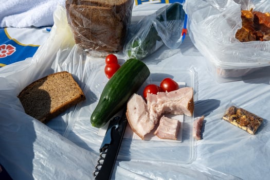 A picnic spread featuring an array of colorful fresh vegetables along with delicious bread photo