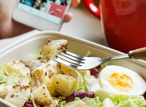 Potato Salad with Boiled Egg and greens in bowl closeup view of Healthy Lunch photo