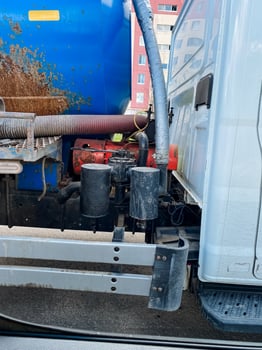 A large white truck is seen, showcasing a blue tank that is securely attached to the rear, highlighting its industrial design and functionality for transporting various materials photo