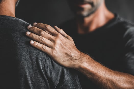 Hand on shoulder showing support photo