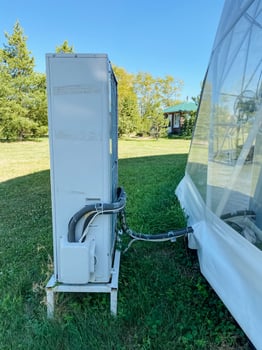 Nestled in a picturesque grassy field, a white refrigerator is securely secured to a strong, durable trailer, creating an ideal spot to enjoy the beauty of nature all around it photo