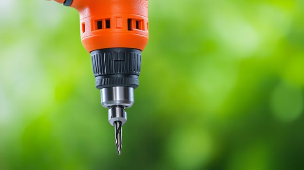 Close-up of a drill against a blurred green background during a DIY project photo