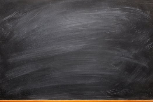 White chalk marks smeared across a black blackboard surface photo