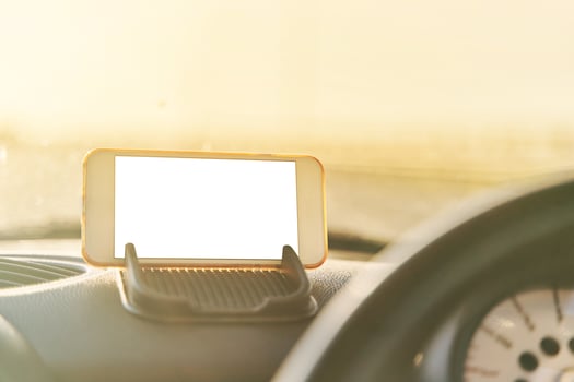 The map on the phone in the background of the dashboard photo