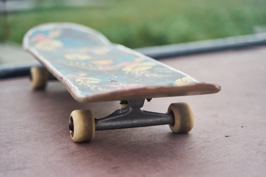 A CloseUp of a Colorful Skateboard Displayed on a Deck with Various Graphics and Colors photo