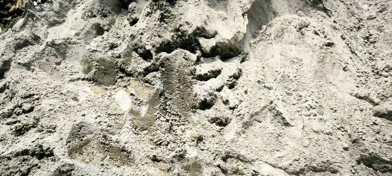 Pile of wet construction sand, abstract background texture. photo