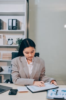 Asian businesswoman working on paperwork in office photo