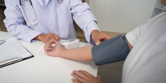 Blood Pressure Measurement. Doctor using device on patient arm. photo