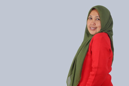 Confident middle aged Muslim woman smiling at camera, isolated studio shot for diversity, lifestyle, and people portrait concepts photo