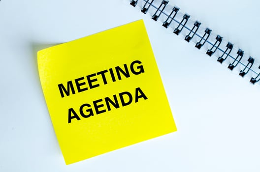 Meeting Agenda text on yellow notepad. Meeting agenda concept photo