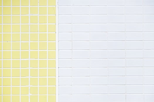 Brick wall with white and yellow tiles photo