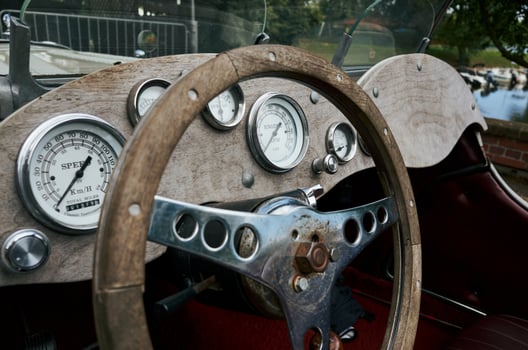 Vintage car with a wooden steering wheel and gauges photo