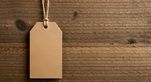 Beige recycled gift tag on jute string against rustic wood. photo