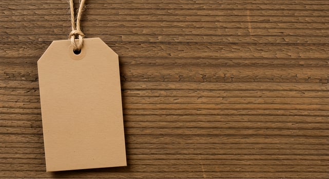Recycled Paper Gift Tag Hanging on Wood with Jute String. photo