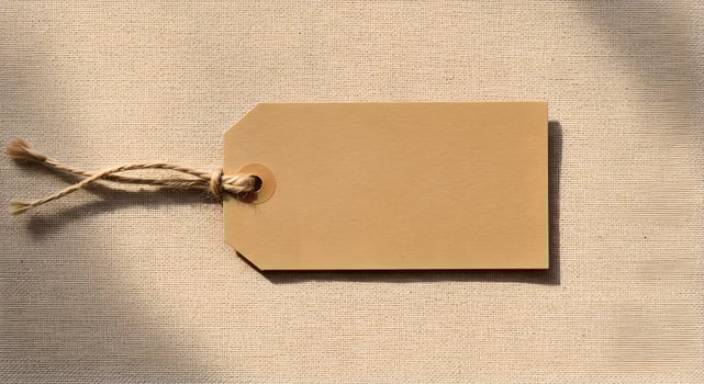 Flat Lay Kraft Paper Tag with Jute Rope on Linen. photo