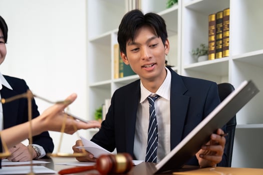Young Lawyer Analyzing Case Files with Colleagues photo