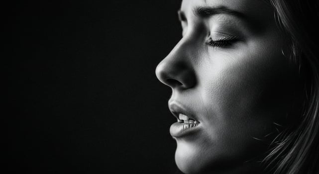A woman with her eyes closed and her mouth open photo