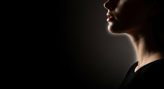 A woman's profile is shown in the dark photo