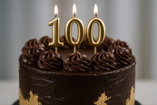 Decadent Chocolate Cake with Gold Details and 100th Celebration Candles Dark Frosting Birthday photo