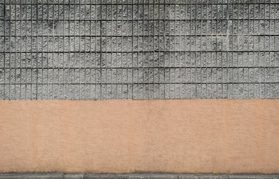 Brick wall with gray bricks and brown bottom photo