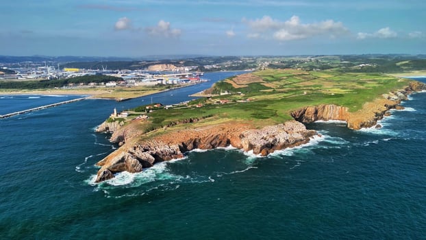This is an Aerial View of a Stunning Coastal Landscape Featuring Dramatic Cliffs and Water photo