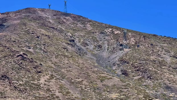 A stunning mountain landscape with communication towers, erosion, beauty, and wildlife photo