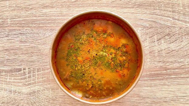 Delicious and Hearty Homemade Vegetable Soup in a Bowl Full of Colorful Ingredients photo