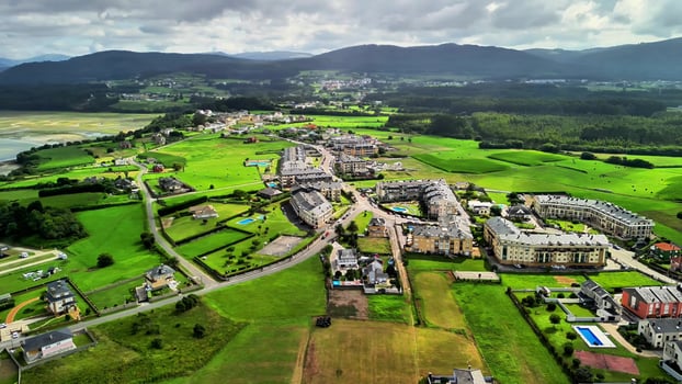 Stunning aerial views of the scenic coast with lush fields and cozy homes nearby photo